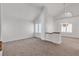 Spacious living room featuring a chandelier, vaulted ceilings, and large windows at 8437 Apple Hill Ct, Las Vegas, NV 89128