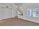 Bright living room with high ceilings, large windows, and carpeted floors at 8437 Apple Hill Ct, Las Vegas, NV 89128