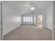A spacious bedroom features neutral carpeting, white walls, a ceiling fan, and lots of natural light at 8437 Apple Hill Ct, Las Vegas, NV 89128