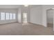 A spacious bedroom features neutral carpeting, white walls, and views into the attached bathroom at 8437 Apple Hill Ct, Las Vegas, NV 89128