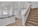 Hallway view features a chandelier, neutral walls, staircase and kitchen at 8437 Apple Hill Ct, Las Vegas, NV 89128