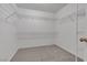 An organized walk-in closet features white wire shelving and neutral carpeting at 8437 Apple Hill Ct, Las Vegas, NV 89128