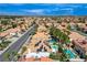 Wide aerial view of homes in a desert community with many having pools and palm trees at 8713 Castle Ridge Ave, Las Vegas, NV 89129