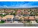Aerial view of a lovely community featuring tile roofs, lush greenery, and manicured lawns at 8713 Castle Ridge Ave, Las Vegas, NV 89129