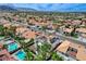 Aerial shot of a residential area showcasing homes with well-maintained landscaping and tiled roofs at 8713 Castle Ridge Ave, Las Vegas, NV 89129