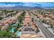 Panoramic aerial view of a community displaying houses with solar panels and desert landscaping at 8713 Castle Ridge Ave, Las Vegas, NV 89129