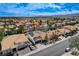 Aerial view showcases a stunning backyard oasis with a pool and patio nestled among mature palm trees at 8713 Castle Ridge Ave, Las Vegas, NV 89129