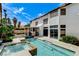 Gorgeous home backyard featuring a pool, spa, covered patio, and lush landscaping at 8713 Castle Ridge Ave, Las Vegas, NV 89129