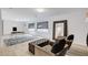 Spacious finished basement with seating area, desk, and wood-look flooring at 8713 Castle Ridge Ave, Las Vegas, NV 89129