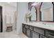 Elegant bathroom featuring dual sink vanity, large mirrors, and a glass-enclosed shower at 8713 Castle Ridge Ave, Las Vegas, NV 89129