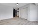 Bedroom with wood-look flooring, large closet, and dark-stained doors at 8713 Castle Ridge Ave, Las Vegas, NV 89129