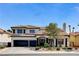 Charming two-story home with a three car garage and nicely landscaped front yard at 8713 Castle Ridge Ave, Las Vegas, NV 89129