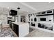 Bright kitchen featuring a large waterfall island, modern appliances, and an open layout to the living space at 8713 Castle Ridge Ave, Las Vegas, NV 89129