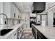 Bright kitchen featuring modern appliances, white cabinets, and an open layout with waterfall island at 8713 Castle Ridge Ave, Las Vegas, NV 89129