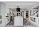 Bright kitchen featuring a large waterfall island, modern appliances, and an open layout with modern finishes at 8713 Castle Ridge Ave, Las Vegas, NV 89129