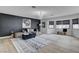 Stylish living room with modern decor, large windows, and a comfortable seating area at 8713 Castle Ridge Ave, Las Vegas, NV 89129