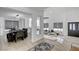 Bright, open-concept living room with modern lighting and dining area with striking decor at 8713 Castle Ridge Ave, Las Vegas, NV 89129