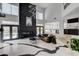 Open-concept living room with fireplace and access to outdoor pool at 8713 Castle Ridge Ave, Las Vegas, NV 89129