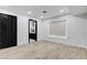Finished room with dark trim and door, and light hardwood flooring at 8713 Castle Ridge Ave, Las Vegas, NV 89129