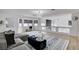 Open living room with high ceilings, clerestory windows, stylish furniture, and modern light fixture at 8713 Castle Ridge Ave, Las Vegas, NV 89129
