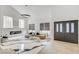 Bright living room with tall ceilings, modern fireplace, modern gray furnishings at 8713 Castle Ridge Ave, Las Vegas, NV 89129