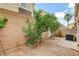 Charming backyard features gravel, a privacy wall, small tree, and air conditioning unit at 9303 Gilcrease Ave # 1056, Las Vegas, NV 89149