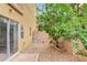 Secluded backyard featuring rock groundcover, brick-lined patio and access to the home at 9303 Gilcrease Ave # 1056, Las Vegas, NV 89149
