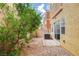 Private backyard with rock groundcover, small tree and access via sliding glass door at 9303 Gilcrease Ave # 1056, Las Vegas, NV 89149