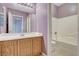 Bathroom featuring a single vanity with wood cabinets and a shower-tub combo at 9303 Gilcrease Ave # 1056, Las Vegas, NV 89149