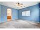 Spacious primary bedroom with ceiling fan, and an open door to the bathroom at 9303 Gilcrease Ave # 1056, Las Vegas, NV 89149
