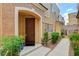 Charming front entrance with a solid door, manicured landscaping, and a well-lit pathway at 9303 Gilcrease Ave # 1056, Las Vegas, NV 89149
