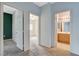 Hallway featuring doorways to a bedroom and a bathroom with a wooden vanity at 9303 Gilcrease Ave # 1056, Las Vegas, NV 89149