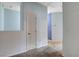Carpeted hallway featuring doors and blue walls, leading to different rooms at 9303 Gilcrease Ave # 1056, Las Vegas, NV 89149