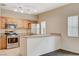 Well-lit kitchen with stainless steel appliances, breakfast bar and ample counter space at 9303 Gilcrease Ave # 1056, Las Vegas, NV 89149