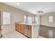 Kitchen area with breakfast bar, stainless steel dishwasher and adjacent living space at 9303 Gilcrease Ave # 1056, Las Vegas, NV 89149