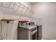 Laundry area with front-loading washer and dryer, complemented by shelving at 9303 Gilcrease Ave # 1056, Las Vegas, NV 89149