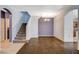 Open-concept living room featuring a staircase, tiled floors, and neutral-toned walls at 9303 Gilcrease Ave # 1056, Las Vegas, NV 89149