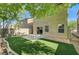 Nice backyard space with artificial turf, a concrete patio, and mature trees at 9452 Plover Falls Ave, Las Vegas, NV 89149