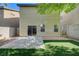 Cozy backyard with artificial turf, patio area, and secure block wall fencing at 9452 Plover Falls Ave, Las Vegas, NV 89149