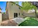 Charming backyard featuring green turf, concrete patio, and desert landscaping at 9452 Plover Falls Ave, Las Vegas, NV 89149