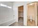 Bright bathroom featuring a shower-tub combo, and a walk-in closet, perfect for relaxing and organizing at 9452 Plover Falls Ave, Las Vegas, NV 89149