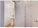 Cozy half-bath is accented with a pedestal sink, unique light fixture, and a mirror at 9452 Plover Falls Ave, Las Vegas, NV 89149