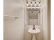 This modern powder room features a pedestal sink, decorative light fixture, and towel bar at 9452 Plover Falls Ave, Las Vegas, NV 89149