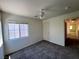 Bedroom featuring a modern ceiling fan and window, next to a door and view of the hallway at 9452 Plover Falls Ave, Las Vegas, NV 89149