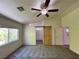 Spacious bedroom with carpet, a ceiling fan, and an ensuite bathroom with a modern barn door at 9452 Plover Falls Ave, Las Vegas, NV 89149