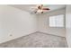 Clean bedroom with large window and ceiling fan, creating a cozy and inviting atmosphere at 9452 Plover Falls Ave, Las Vegas, NV 89149