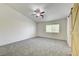 Bedroom with a window, ceiling fan, and a sliding barn door at 9452 Plover Falls Ave, Las Vegas, NV 89149