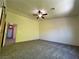 Bright and spacious bedroom featuring plush carpet, ceiling fan, and an ensuite bathroom at 9452 Plover Falls Ave, Las Vegas, NV 89149