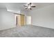 Carpeted bedroom with a ceiling fan and sliding barn door to bathroom at 9452 Plover Falls Ave, Las Vegas, NV 89149