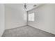 Inviting bedroom with natural light, plush carpeting, and modern ceiling fan at 9452 Plover Falls Ave, Las Vegas, NV 89149